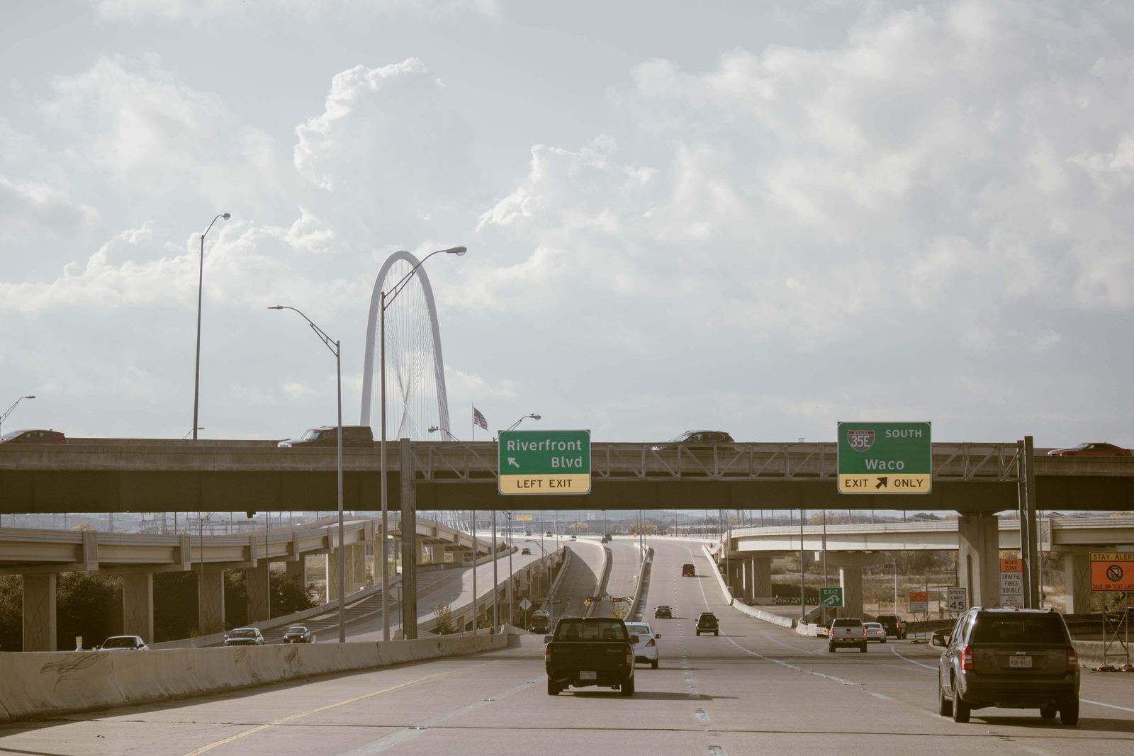 Cars and traffic on a wide open Texas interstate under a big sky