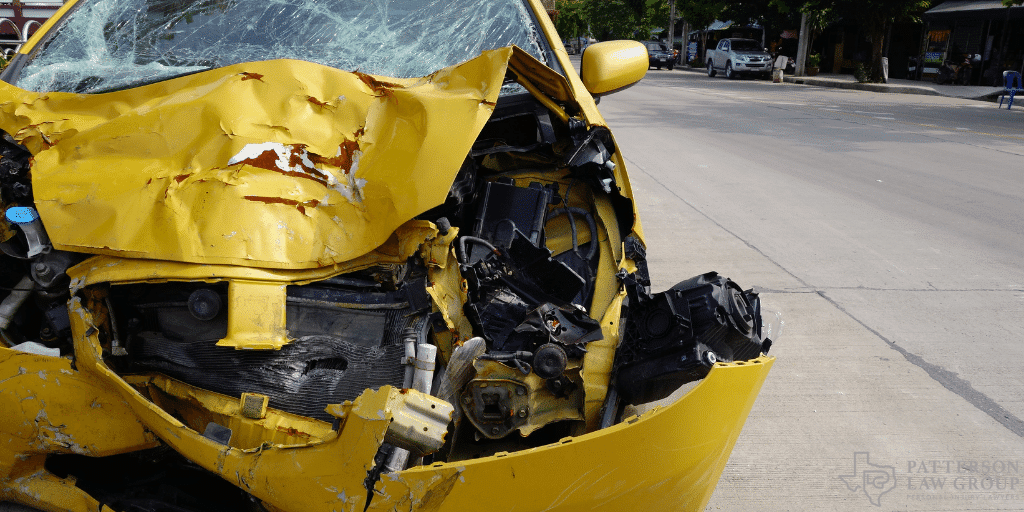 a damaged yellow car on the street